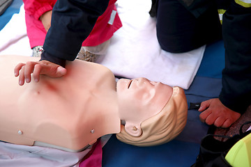 Image showing Practicing CPR chest compressioon on a dummy