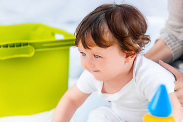 Image showing Happy baby boy sitting with toy