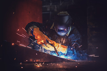 Image showing worker welding metal