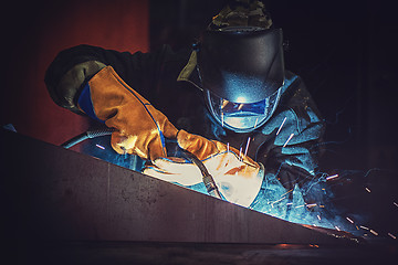 Image showing worker welding metal