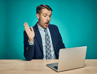 Image showing Sad Young Man Working On Laptop At Desk