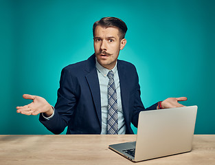 Image showing Sad Young Man Working On Laptop At Desk