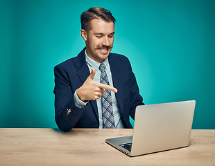 Image showing Sad Young Man Working On Laptop At Desk