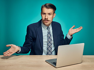 Image showing Sad Young Man Working On Laptop At Desk