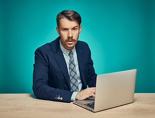 Image showing Sad Young Man Working On Laptop At Desk