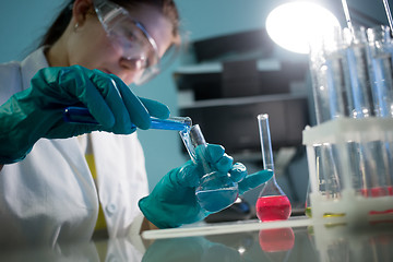 Image showing Technician with flasks and tubes