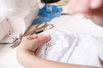 Image showing Seamstress working with white cloth