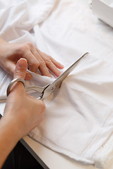 Image showing Woman tailors with scissors cloth