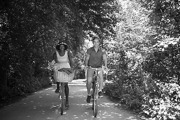 Image showing Young multiethnic couple having a bike ride in nature