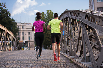 Image showing multiethnic couple jogging in the city