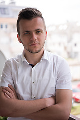 Image showing man standing at balcony