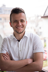 Image showing man standing at balcony