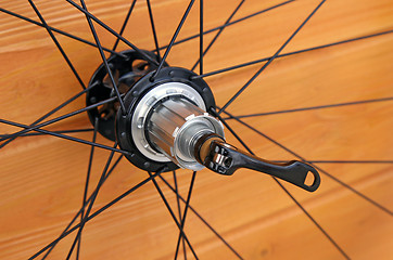 Image showing bike rear wheel against brown background.