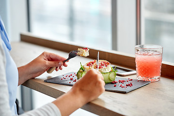 Image showing woman eating goat cheese salad at restaurant