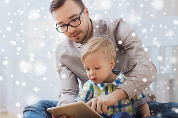 Image showing father and son with tablet pc playing at home