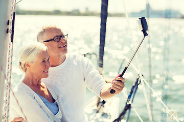 Image showing senior couple taking selfie on sail boat or yacht