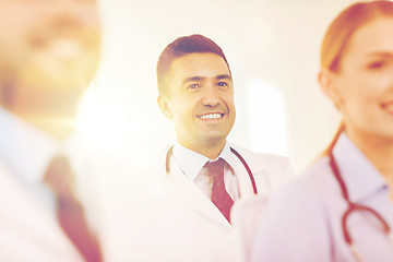 Image showing happy doctor over group of medics at hospital