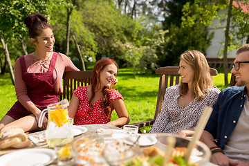 Image showing happy friends having dinner at summer garden party