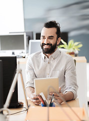 Image showing happy creative male office worker with tablet pc