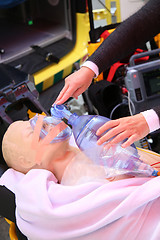 Image showing Practicing to use an oxygen mask on training doll