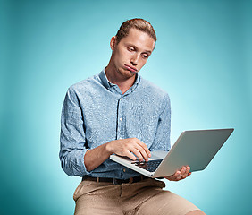 Image showing Sad Young Man Working On Laptop