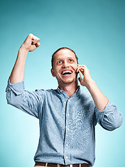 Image showing The young smiling caucasian man on blue background