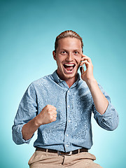 Image showing The young smiling caucasian man on blue background