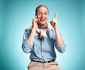 Image showing The young smiling caucasian man on blue background