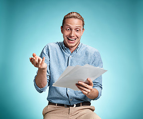 Image showing Smart smiling student with great idea holding notebook