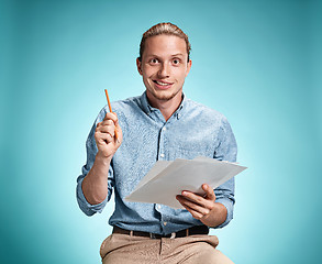 Image showing Smart smiling student with great idea holding notebook