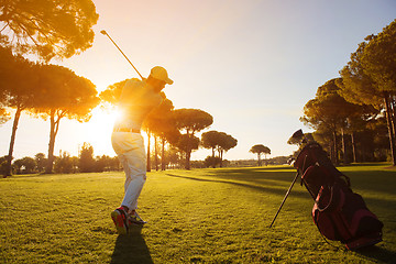 Image showing golf player hitting shot with club