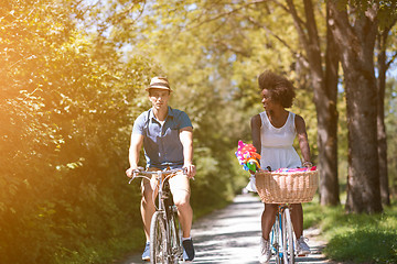 Image showing Young multiethnic couple having a bike ride in nature