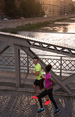 Image showing young multiethnic couple jogging in the city