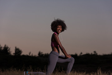 Image showing black woman is doing stretching exercise relaxing and warm up