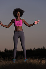 Image showing black woman is doing stretching exercise relaxing and warm up