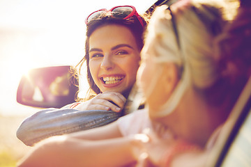 Image showing happy teenage girls or women in car at seaside