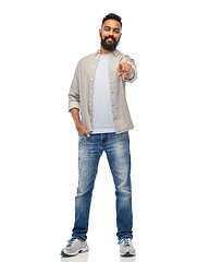 Image showing happy smiling indian man pointing finger to you