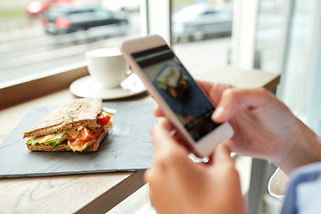 Image showing hands with smartphone photographing food