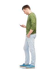 Image showing young man texting on smartphone over white