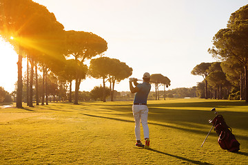 Image showing golf player hitting shot with club