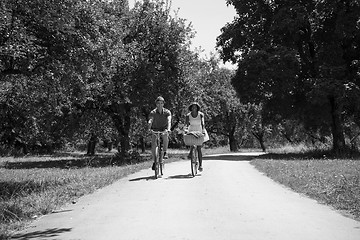 Image showing Young multiethnic couple having a bike ride in nature