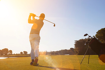 Image showing golf player hitting shot with club