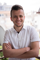 Image showing man standing at balcony