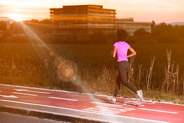 Image showing a young African American woman jogging outdoors