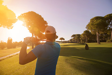 Image showing golf player hitting shot with club