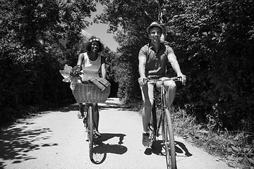 Image showing Young multiethnic couple having a bike ride in nature