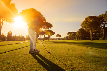 Image showing golf player hitting shot with club