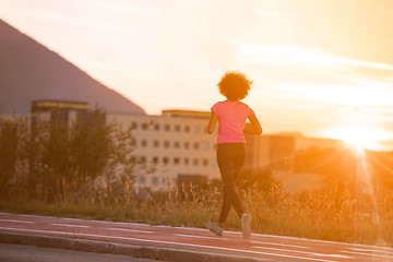 Image showing a young African American woman jogging outdoors