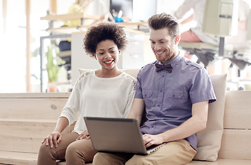 Image showing happy creative team with laptop in office