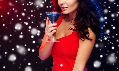 Image showing close up of beautiful woman with cocktail at night